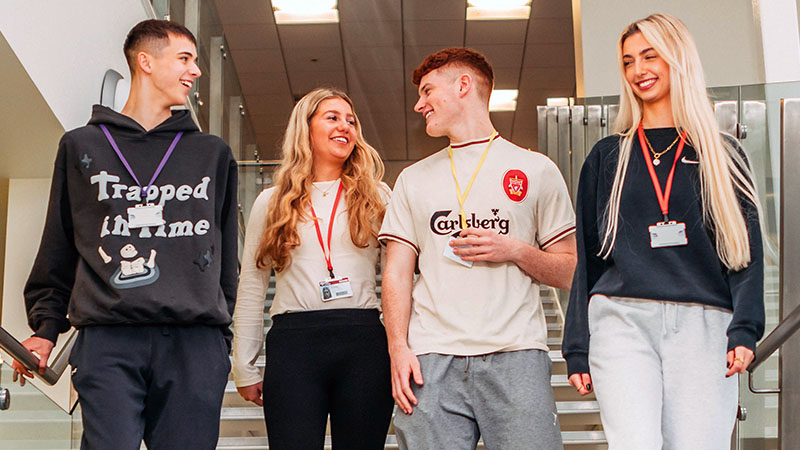 Four students walking down stairs at Selby College