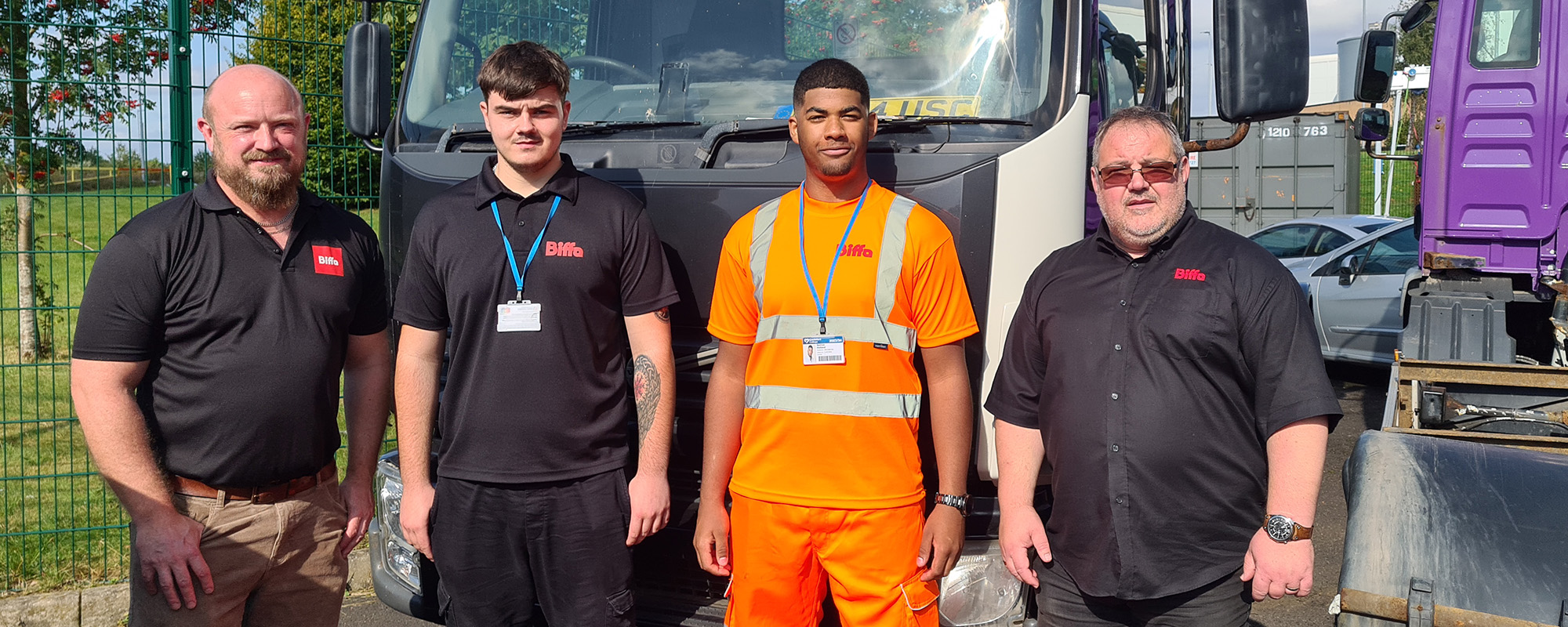 Automotive students next to a HGV