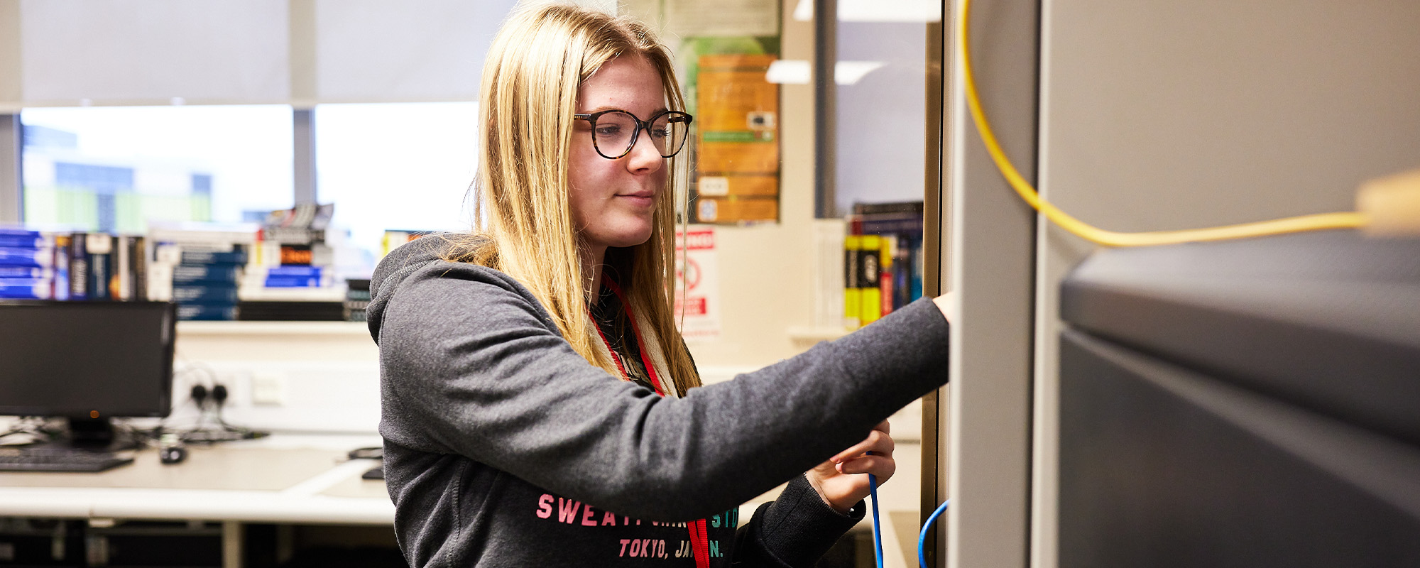 A student working on IT networking equipment