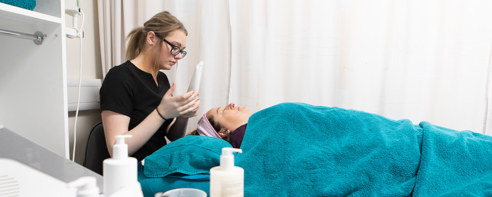 Beauty student with a client during a treatment