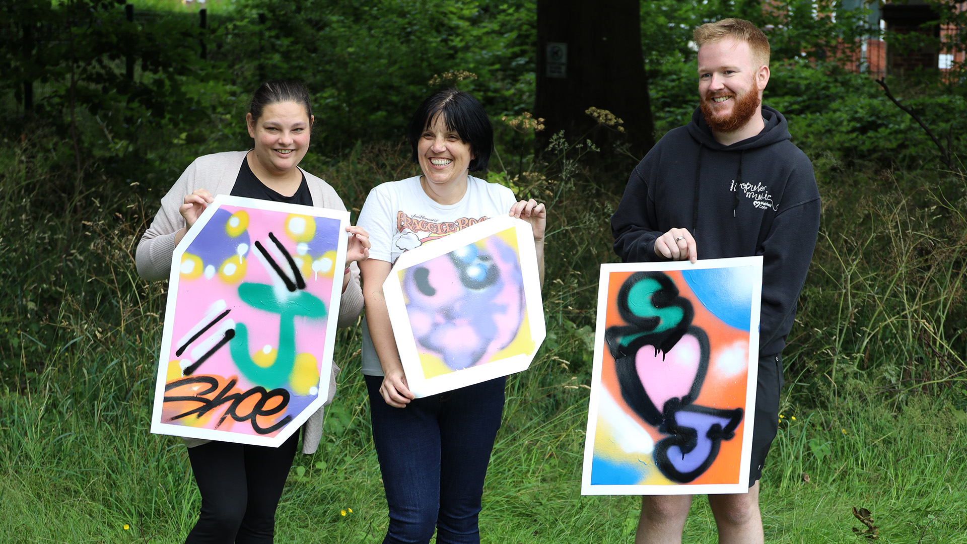 Staff showing their art projects on staff development day