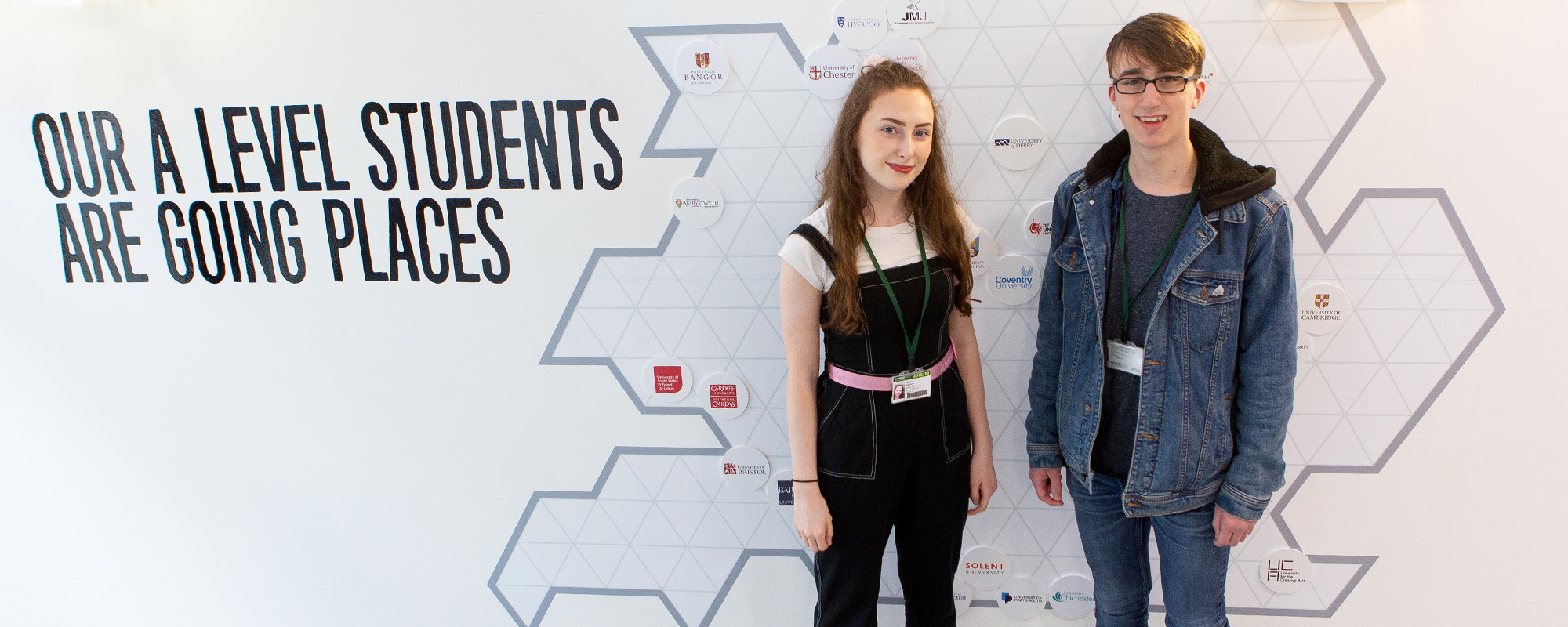 Two A level students stood next to a destinations map