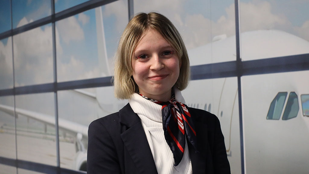 Air Cabin Crew student stood in front of an airport window