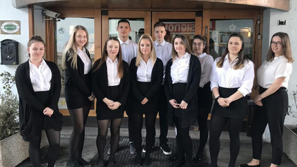 The students outside the hotel they worked in