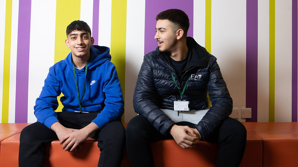 Two students sat down and socialising 