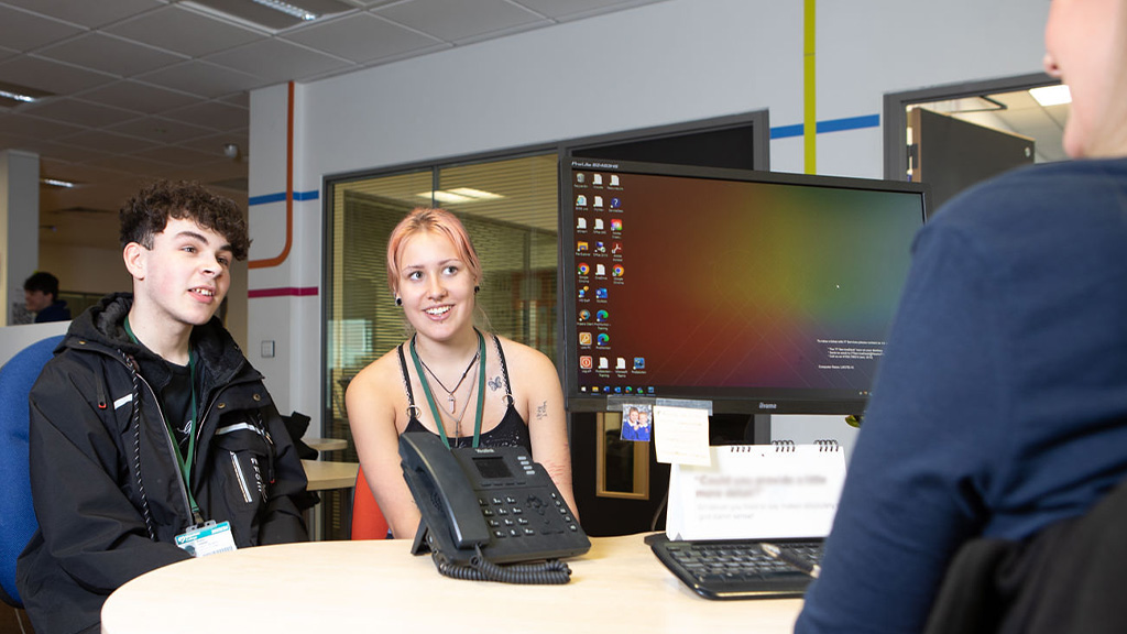 Students talking to staff member 