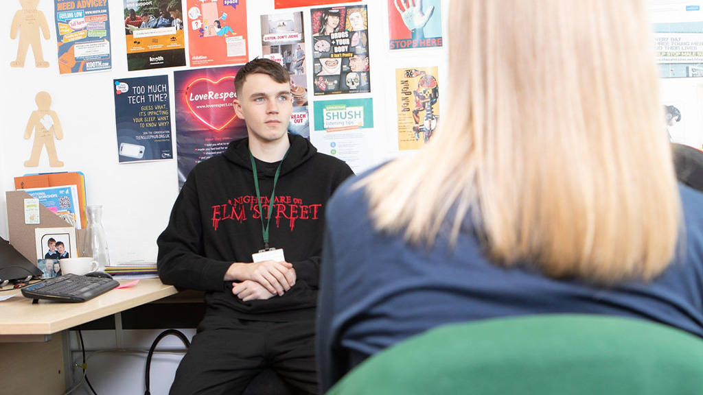 Student talking to a Staff member in an office