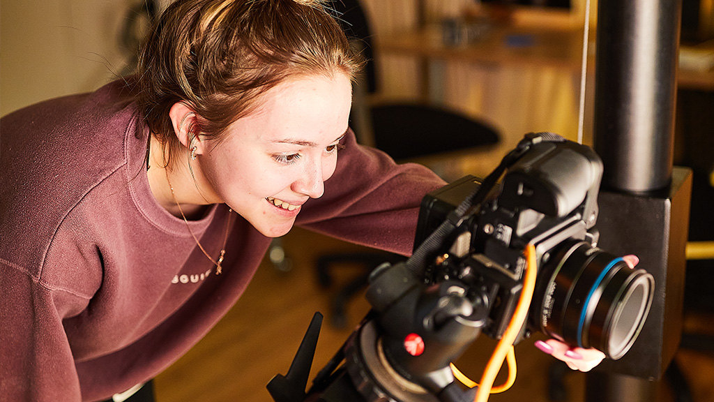 Student taking photos on a camera