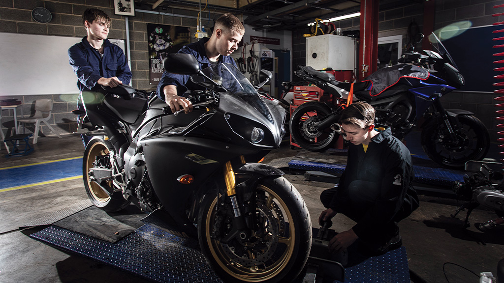 Students working on bike in workshop