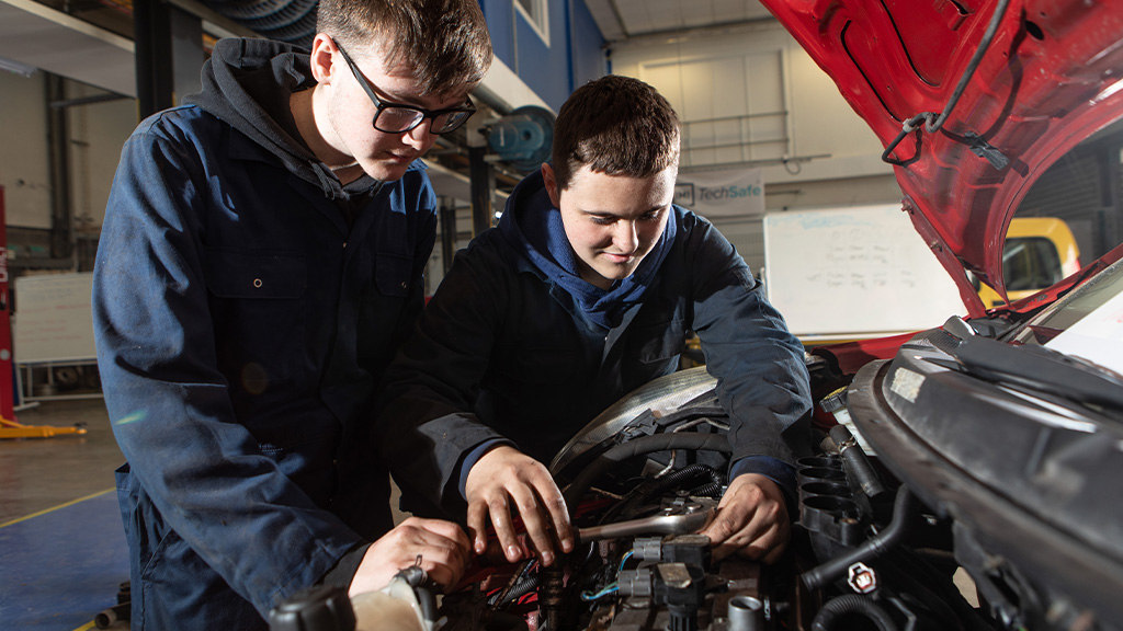 Two students working on a car