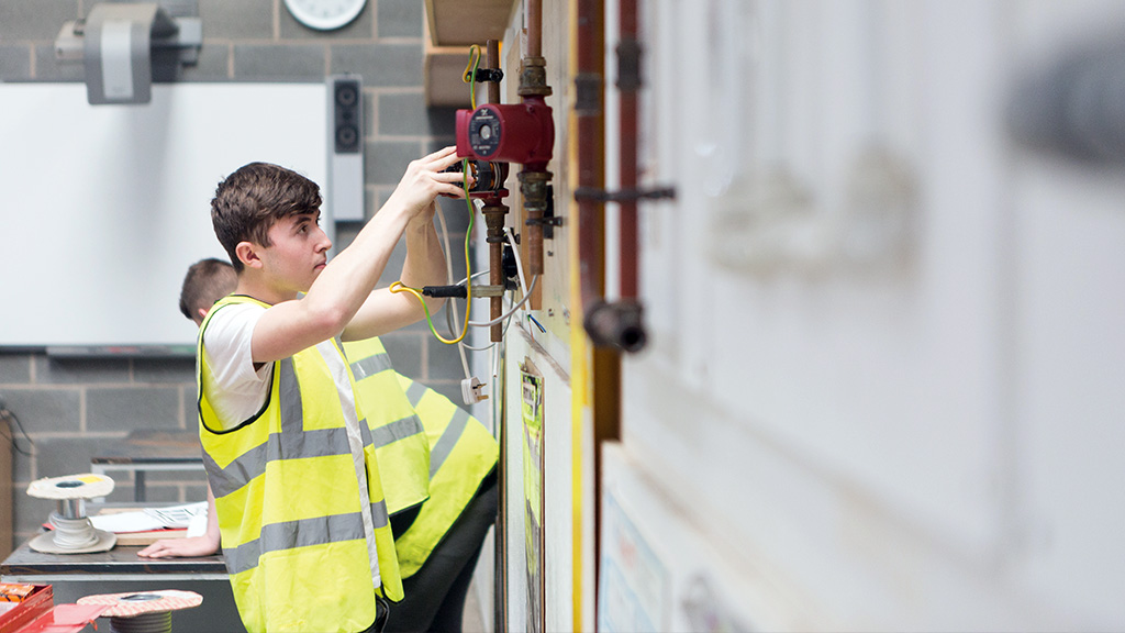 Student practising plumbing skills