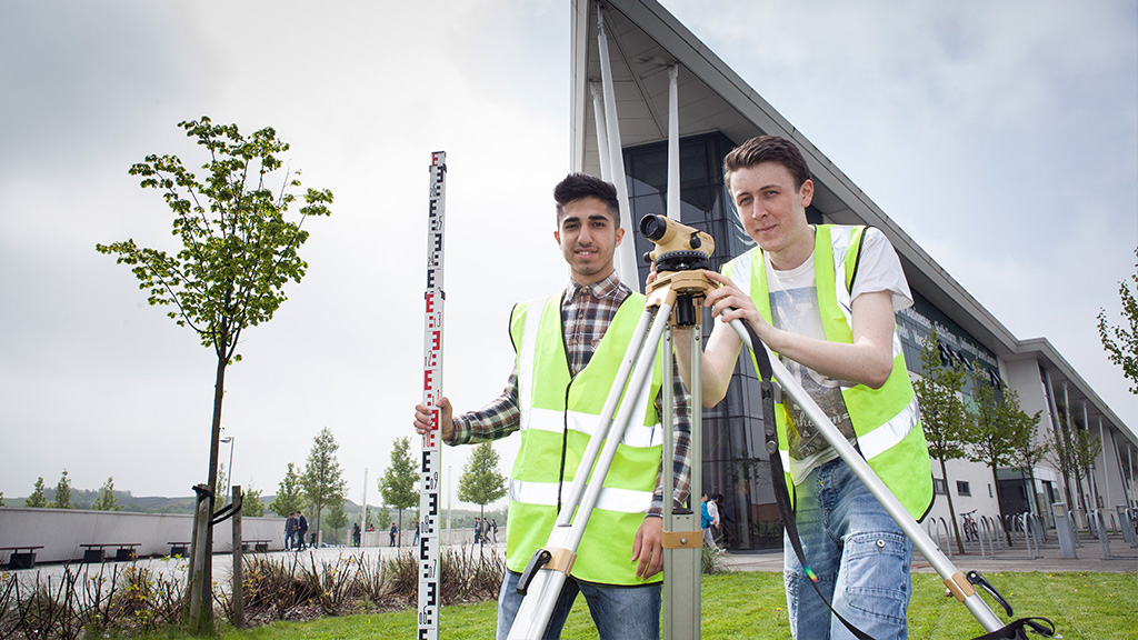 Students using surveying equipment