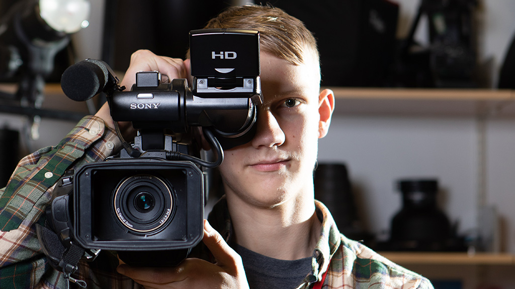 Media student holding a video camera