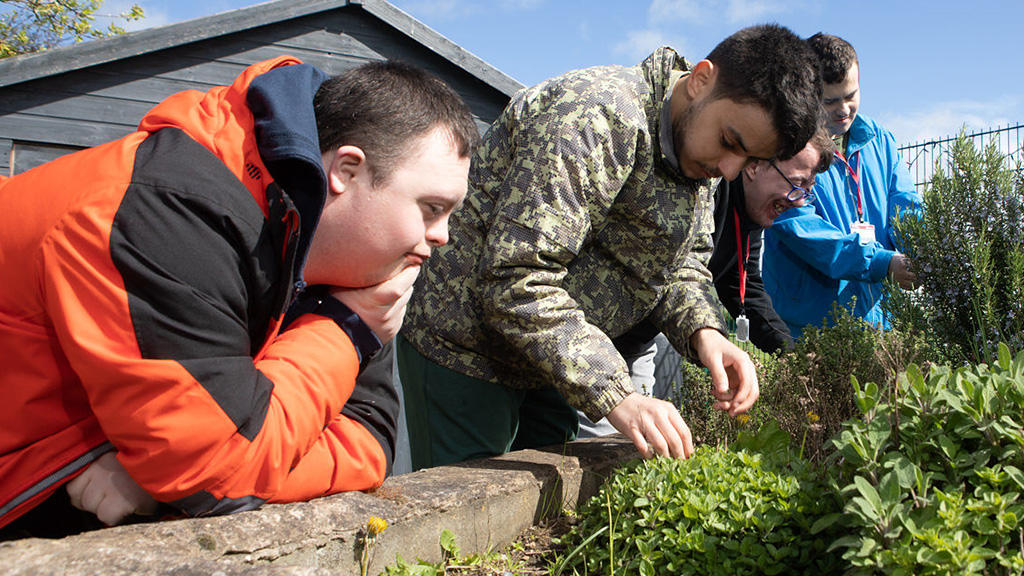 Two foundation learning students in the college garden