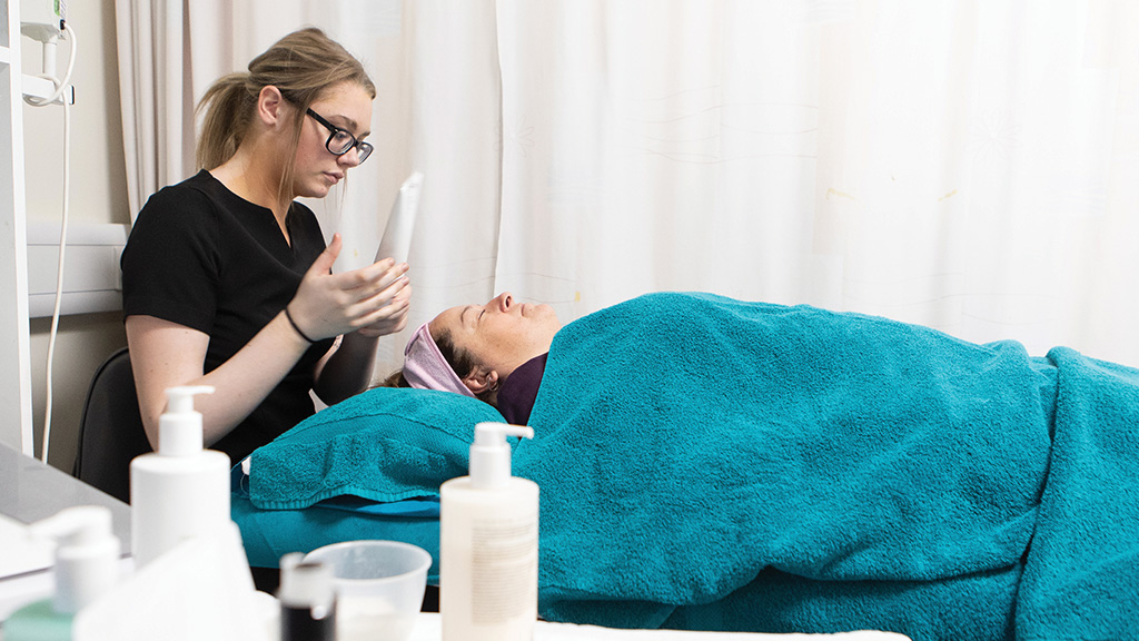 Students practises facial techniques