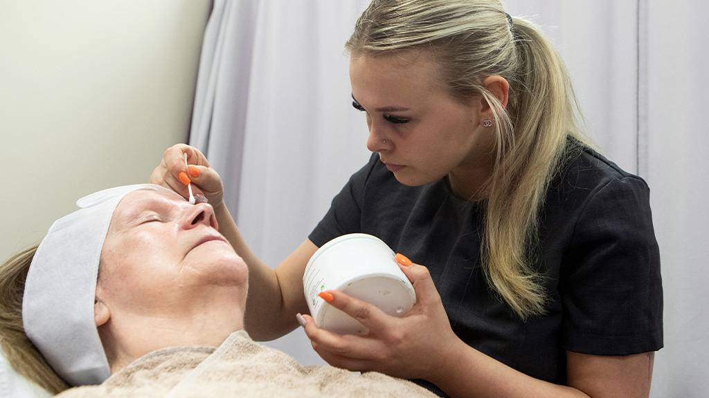 Student performing a beauty therapy treatment on a client