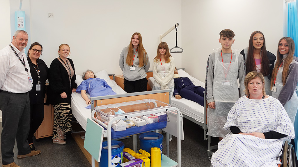 Healthcare students and tutors in mock hospital