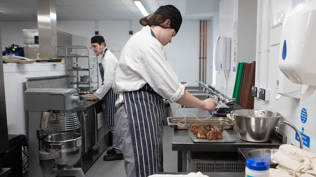 Student preparing a dish in the kitchen