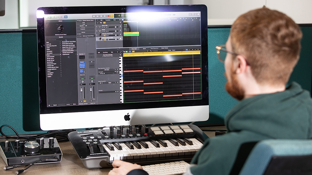 Student working on a music mixing desk