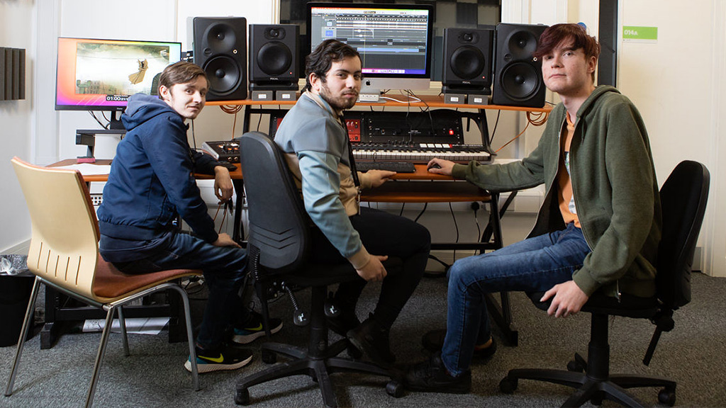 Group of students working in a music studio