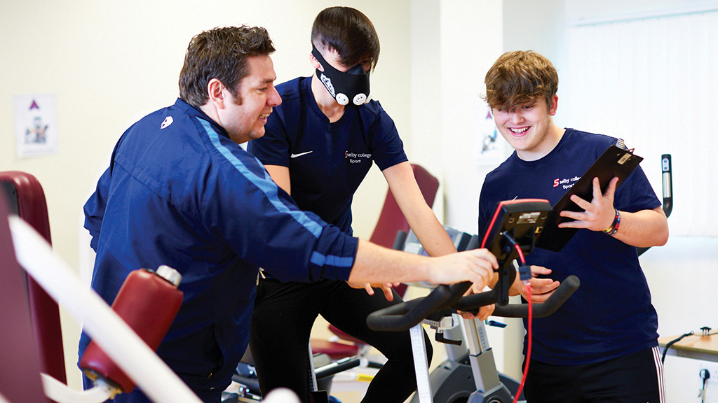 Students and tutor around an exercise bike