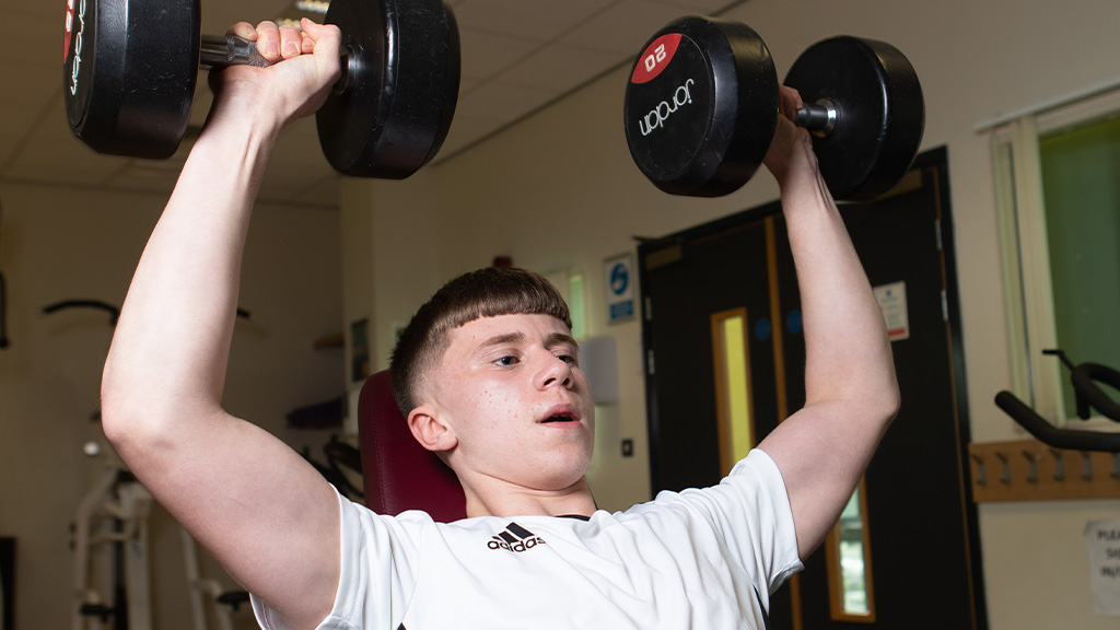 Student lifting weights 